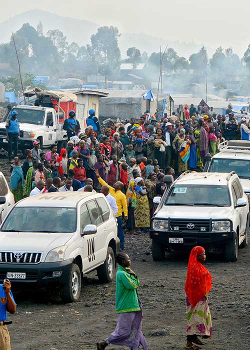 Several UN cars on a crowded street in North Kivu province, Democratic Republic of the Congo