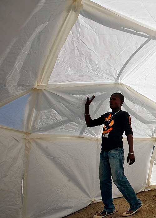 Staff member walking in newly erected tent
